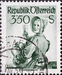 Austria - circa 1951 : a postage stamp from Austria, showing a woman in national costume from the region: Lower Austria (circa 1850)