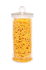Uncooked pasta in glass jar on white background.