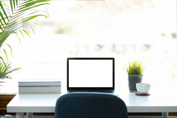 Fototapeta premium Mockup image of laptop computer with blank white screen on working space at home office