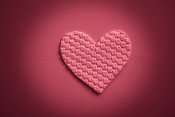 Fabric heart on the table. Red light tone