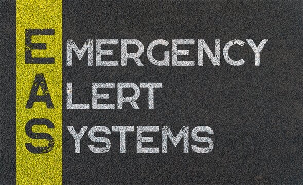 Emergency alert systems (EAS), EAS acronym written over road marking yellow paint line. acronyms and abbreviations.