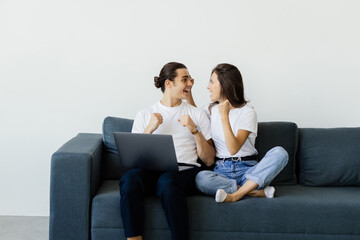 Overjoyed excited couple getting good news, celebrating success, goal achieving, winning prize....