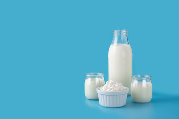 Milk kefir drink on wooden table. Liquid and fermented milk product on blue background	