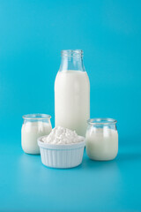 Milk kefir drink on wooden table. Liquid and fermented milk product on blue background	