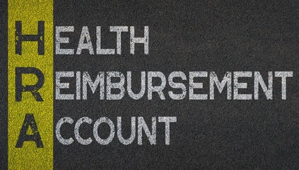 Health reimbursement account - HRA acronym written over road marking yellow paint line. acronyms and abbreviations.