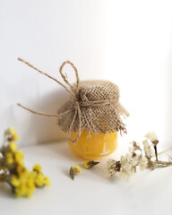 Tasty sweet honey in the jar with flowers, food photo, herbal honey