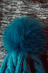 Blue knitted hat on a gray background
