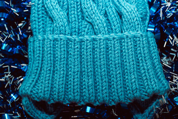 Blue knitted hat on a blue background