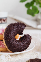 Chocolate donut close up ona a white background.