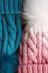 Fototapeta na wymiar Blue and pink knitted hat on a gray background