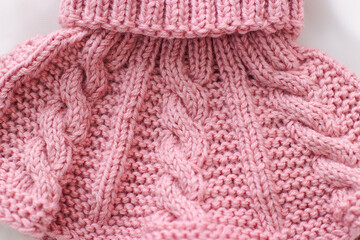 Pink knitted scarf on a white background