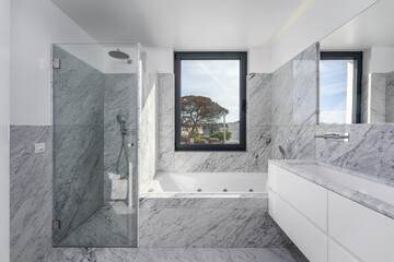 Bathroom with gray tones and stone with shower and bathtub