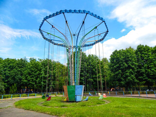 chain carousel in city park in sunny summer