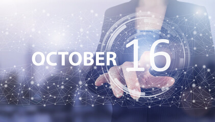 October 16th. Day 16 of month, Calendar date. Hand click luminous hologram calendar date on light blue town background. Autumn month, day of the year concept.