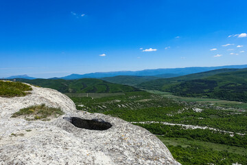 View of the picturesque Crimean mountains from the cave town of Tepe-Kermen in summer. May. 2021. Crimea. Russia.