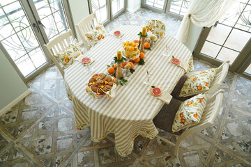 Table with orange cookies, fruits snacks.
