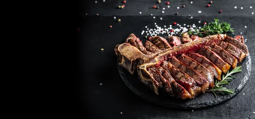 Foto op Canvas Traditional American barbecue dry aged steak sliced. porterhouse steak sliced as top view on a slate board. banner, catering menu recipe place for text © Надія Коваль