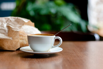 Cup of coffee latte on in a cafe on a wooden table