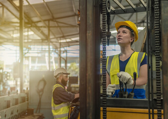 Fototapeta na wymiar workers wearing safety helmet and vest working in warehouse
