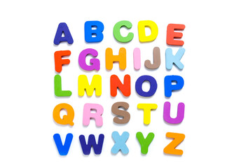 English alphabet made of square wooden tiles with the English alphabet scattered on white background.