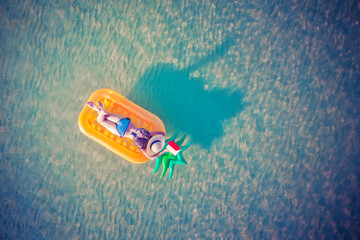 Fototapeta na wymiar .woman in bikini enjoy swimming on inflatable tube at the sea island, summertime enjoyment in the sea alone, weekend and vacation enjoyment in the sea summertime