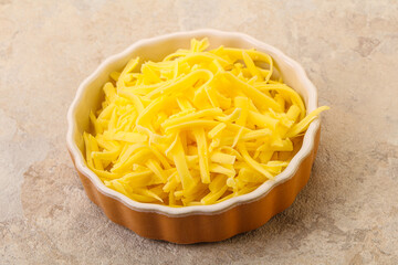 Shredded yellow cheese in the bowl