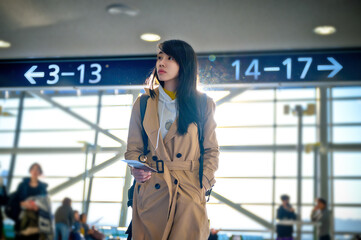 woman traveler passenger in motion of urgent hurry to find-out the gate way terminal to check-in boarding pass, urgent to get the gate for boarding the air craft in time limitation