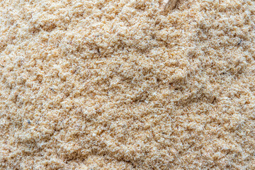 Small sawdust unevenly sprinkled as a background or texture