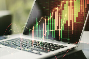 Double exposure of abstract creative financial diagram on modern laptop background, banking and accounting concept
