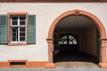 View of a house facade with a window and an archway 