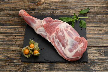 Lamb shoulder on a natural stone and wood background
