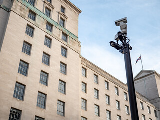 Fototapeta na wymiar Security CCTV cameras watching over an anonymous Ministry of Defence government building in Whitehall, the heart of UK politics and governance.