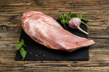 Calf shoulder blade on bone chilled on a natural wooden background