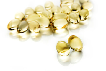 macro composition of vitamin D3 capsules with selective focus on white background.