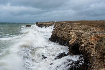 Fototapeta na wymiar Dramatic seascape with rocks and waves - copy space