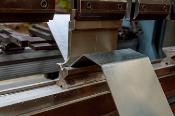 Bending of sheet metal parts using a bending machine. Production of metal parts.