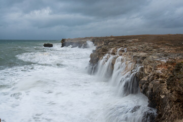 Fototapeta na wymiar Dramatic seascape with rocks and waves - copy space