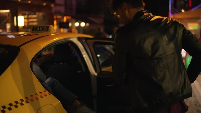a man and a girl get into a taxi