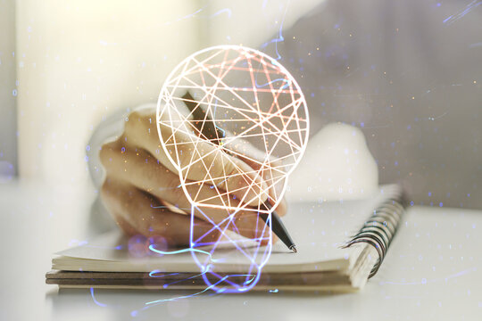 Double exposure of creative light bulb hologram with hand writing in diary on background, research and development concept