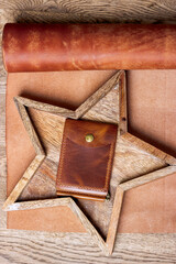 Money clip made of genuine leather on a leather background