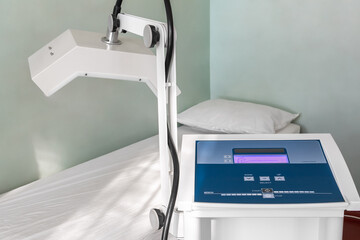 Close-up detail view of physiotherapy medical diathermy treatment equipment. Microwave therapy room with couch. Physical rehabilitation service device at hospital. Healthcare modern technologies