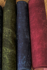 Rolls of genuine leather on a wooden table