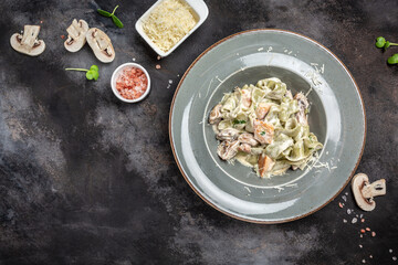 Tagliatelle pasta with chicken and cream mushroom sauce. Italian cuisine. banner, menu, recipe place for text, top view