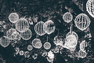 light garlands in the form of a ball hung on a tree