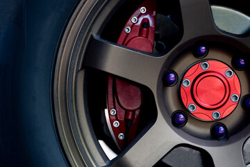 
Alloy gold car wheels with red brake calipers.
