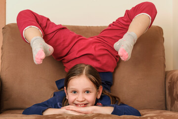 Upside down portrait of nice cute charming attractive cheerful girl lying on divan having fun in...