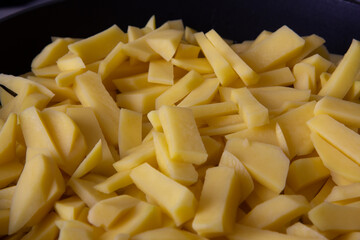 Crispy golden potatoes in a frying pan in the kitchen 