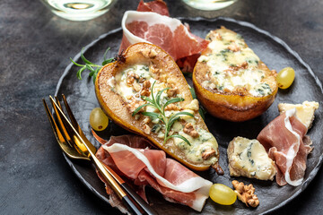 Appetizer with pear baked with blue cheese, nuts and honey, prosciutto. Summer snacks. Pear appetizer with jamon, Long banner format. top view.