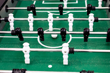 Table football with black and white figures close up