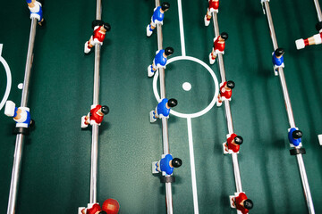 Table football with red and blue figures close up